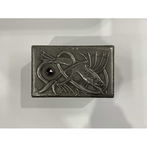 139B - A wooden foil lined tea caddy, pewter repousse lid depicting a leaping fish with facet moulded purpl... 