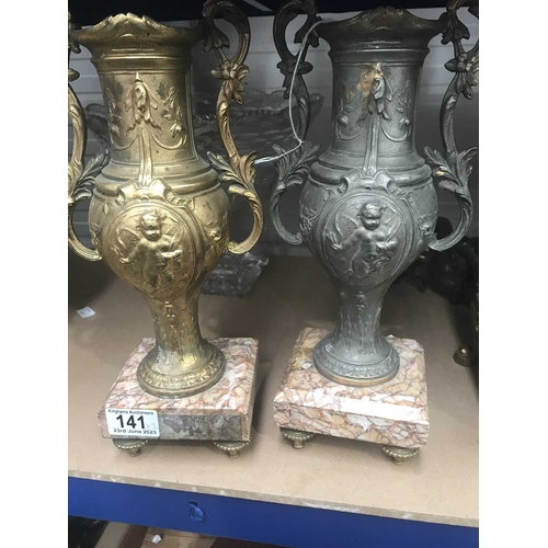 141 - A pair of cast art metal pedestal vases, baluster twin handled form, on square chamfered marble base... 