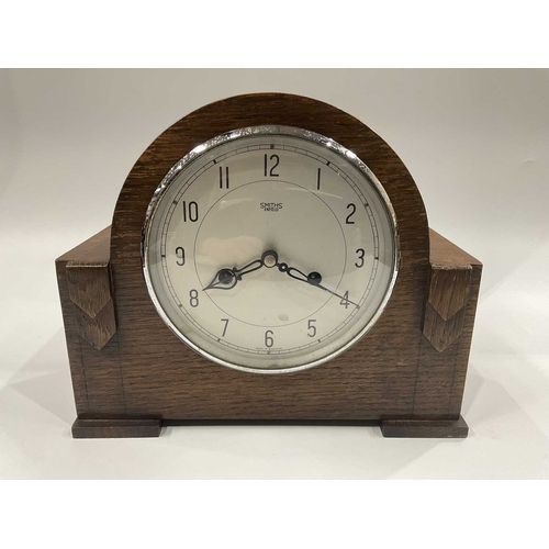 141C - A Smiths Enfield oak cased mantel clock, together with a silver plated wooden lined cigarette box, e... 