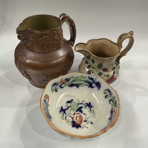 141D - A large 19th Century salt glazed stoneware pitcher, sprigged Prince of Wales heraldry and motifs and... 