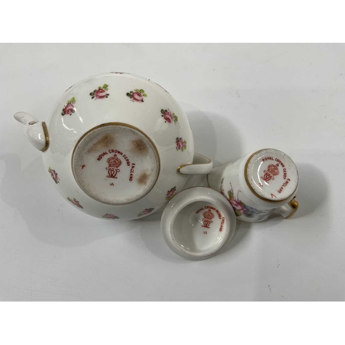 146C - A Royal Crown Derby rose painted miniature teapot, 5cm high and a miniature cream jug decorated with... 