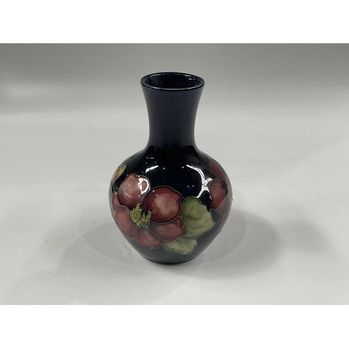 146E - Walter Moorcroft, a clematis pattern vase, baluster form, painted signature and label, 13cm high