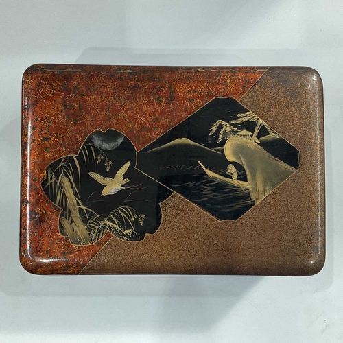 149F - A Japanese papier mache black laquered box, decorated with boating figure and birds in lozenge and p... 