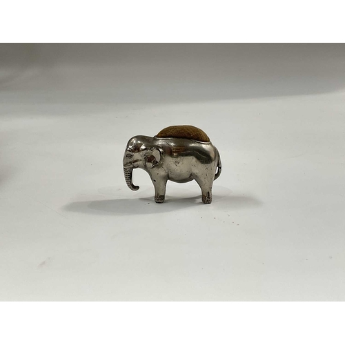 150A - A Cast metal pin cushion, modelled as a standing elephant, 4cm high, together with a James Dixon pew... 