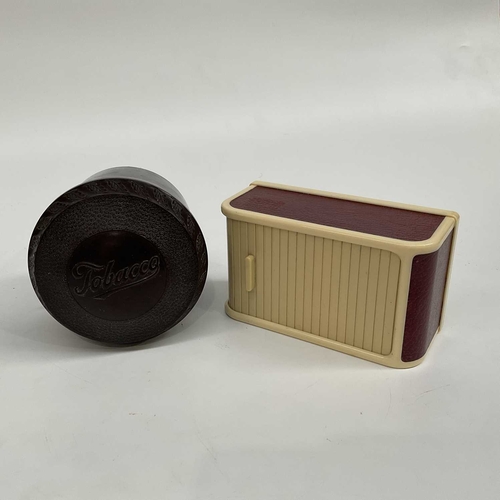 156D - An Art Deco Rolinx bakelite roll top cigarette dispenser, together with a bakelite tobacco jar, scre... 