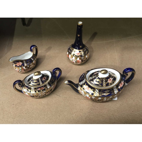 157E - A Royal Crown Derby miniature tea set, circa 1930, Old Witches pattern, comprising teapot, sucrier a... 