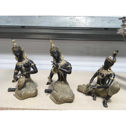 159B - A set of three decorative gilt metal and bronzed Thai deities, seated playing musical instruments, 3... 