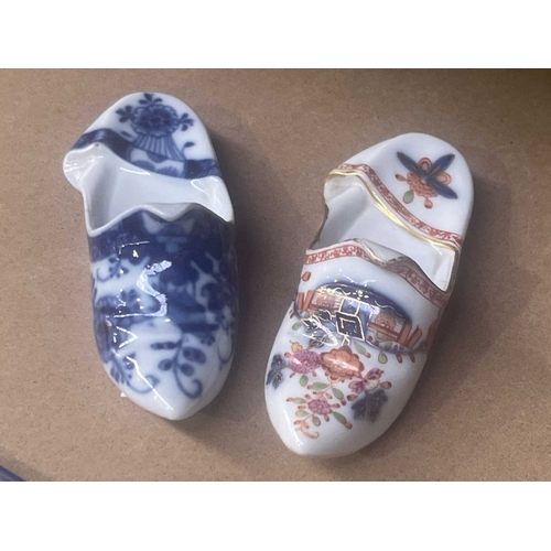 159D - A Meissen blue and white painted slipper, with trodden back and peaked rim, 9cm long, and another si... 