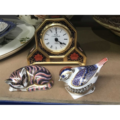 161C - A Royal Crown Derby Old Imari pattern clock, 10cm high, together with two Royal Crown Derby paperwei... 