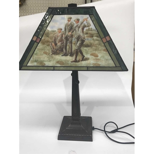 161D - A reproduction desk lamp, the trapezium shaped shade painted with golfing scenes, on a cast metal ba... 