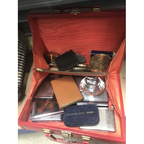 165 - A collection of yellow metal compacts, cigarette cases and lighters, in red leather case