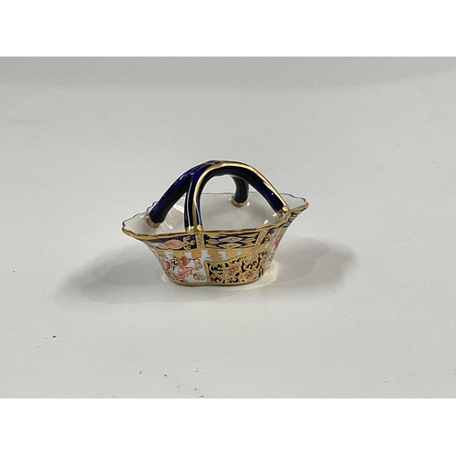 180A - A Royal Crown Derby Witches pattern miniature basket, crimped quarter lobed form, with cojoined loop... 