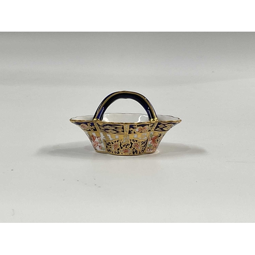 180A - A Royal Crown Derby Witches pattern miniature basket, crimped quarter lobed form, with cojoined loop... 