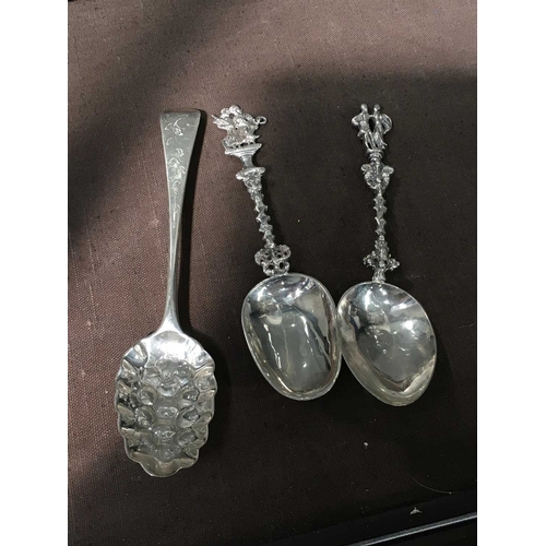 209 - Three silver spoons, including two Dutch cast figural handle spoons, and a George III berry spoon, 5... 