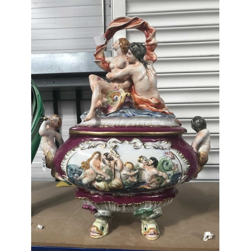 218 - A large Capodimonte relief moulded tureen and cover, modelled with figures, 42cm long