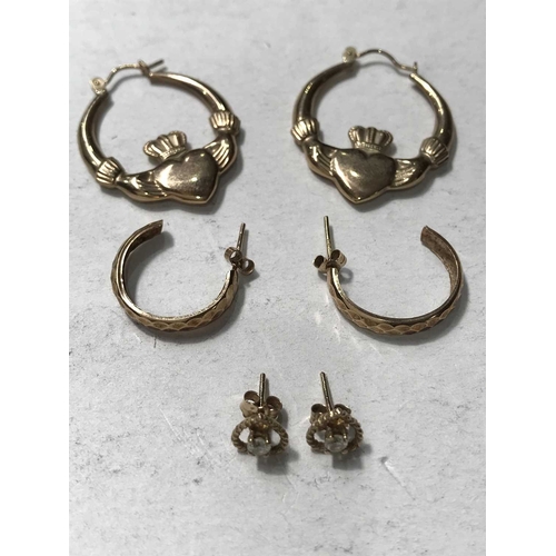 221 - Three pairs of yellow metal earrings, including hands holding heart hoop earrings, half hoop earring... 