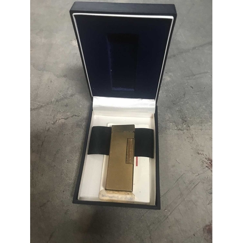 260 - Alfred Dunhill, gold plated Rollagas lighter, engine turned, 6.5cm long, in case of issue