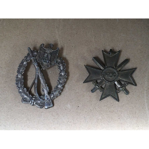 267 - Two WWII German badges, including an Infantry Assault Badge in silver and a War Merit cross dated 19... 