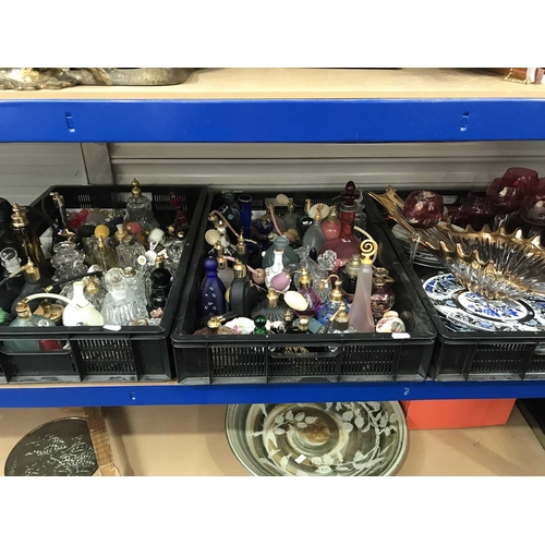 276 - A large collection of glass scent bottles, perfume and atomisers, together with plates, cranberry sh... 