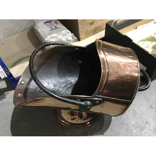 338 - A mid 19th century copper helmet shaped coal scuttle with wrought iron swing over handle