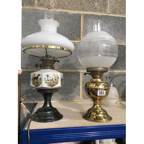 363 - Two oil lamps - ceramic reservoir printed with hunting dogs and one brass oil lamp (2)