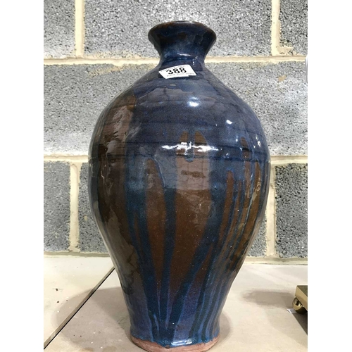 388 - A studio pottery coil pot, inverse baluster form, blue streaked glazed on brown ground, unmarked