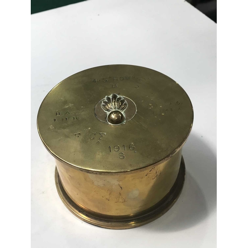 402 - A WWI brass 4.5 Howitzer shell case, impressed marks and with button and badge embellishments