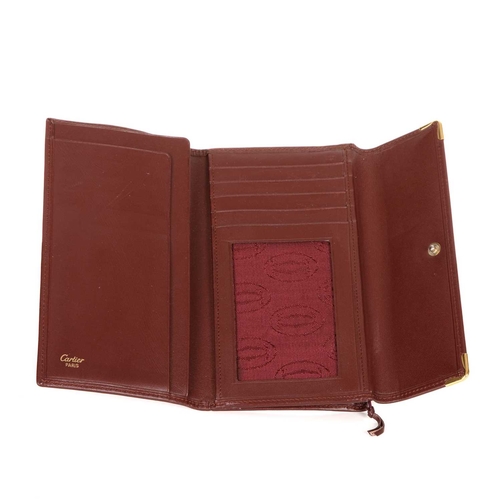 Cartier, a Bordeaux leather wallet, crafted from smooth burgundy ...