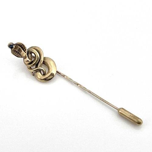 10 - A 9ct gold stick or tie pin with coiled cobra finial, set sapphire, hallmarked, 3.7g