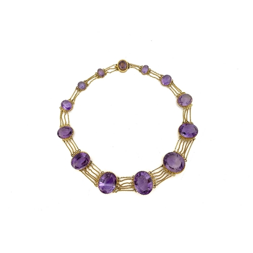 30 - A Victorian amethyst and yellow metal necklace, circa 1860, the thirteen graduated facet cut stones ... 