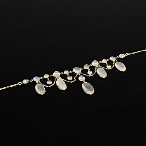 32 - A late 19th Century gold moonstone fringe necklace, on a later integral curb-link chain, chain stamp... 