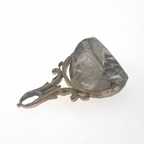 34 - A mid-19th Century gold mounted triple facet cut quartz intaglio swivel fob seal, 4cm high