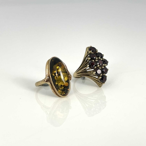 38 - A 9ct gold garnet cluster ring and a 9ct gold amber ring, ring sizes: P/P 1/2 and M 1/2, 7.2g (2)