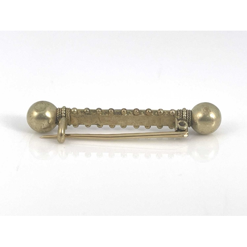 42 - An Etruscan revival yellow metal and split pearl bar brooch, double ended baton form with spherical ... 