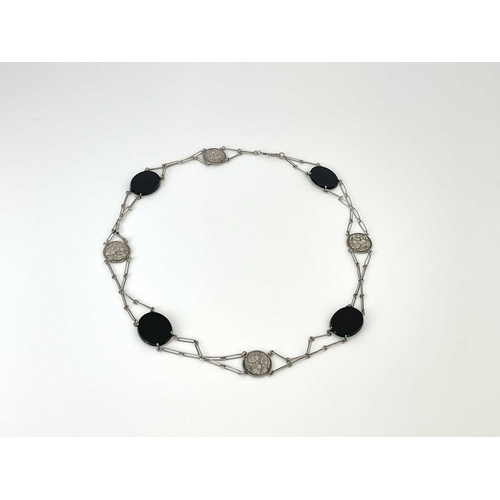 51 - An Art Nouveau white metal and onyx belt or necklace, alternating plaques of relief cast maiden and ... 