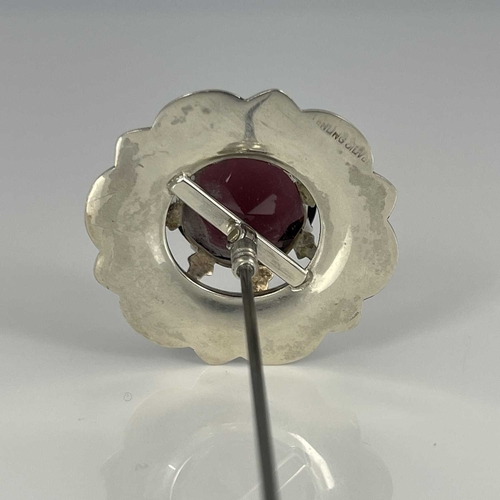 7 - A silver and Scottish hardstone set thistle hat pin, the central amethyst within a chased frame of s... 