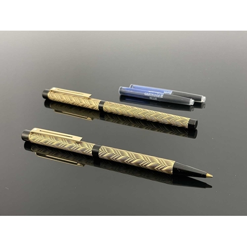 70 - Sheaffer, a Targa Slim fountain pen and ballpoint, circa 1980s, gilt weave over black, 14 carat gold... 