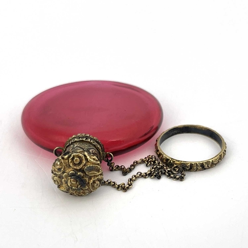 77 - A Victorian silver gilt and cranberry glass scent bottle, circa 1840, the flattened disc form body w... 