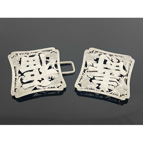 83 - A Chinese silver buckle, each shaped rectangular panel pierced and chased with the characters for Lo... 