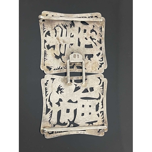 83 - A Chinese silver buckle, each shaped rectangular panel pierced and chased with the characters for Lo... 