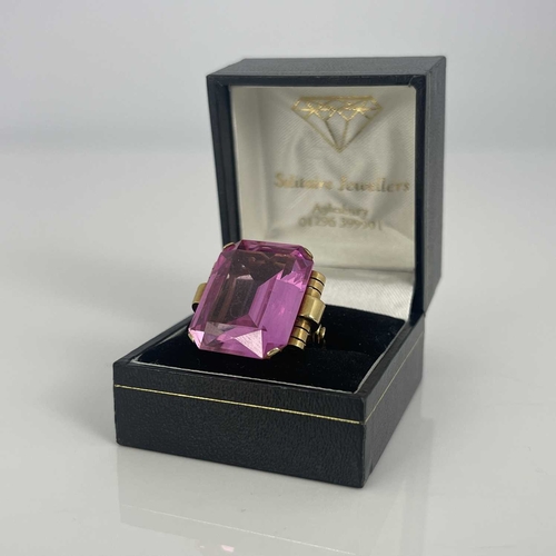 9 - A yellow gold ring, set emerald-cut pink stone, (possibly synthetic)