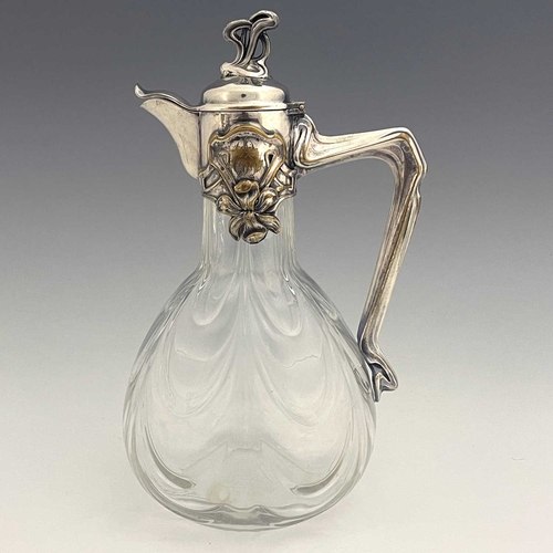 92 - A Jugendstil silver plate and glass claret jug, circa 1900, the optic swag moulded body of bulbous f... 