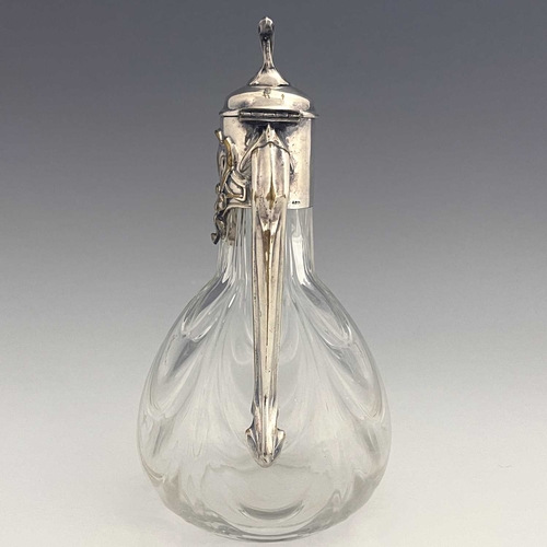 92 - A Jugendstil silver plate and glass claret jug, circa 1900, the optic swag moulded body of bulbous f... 