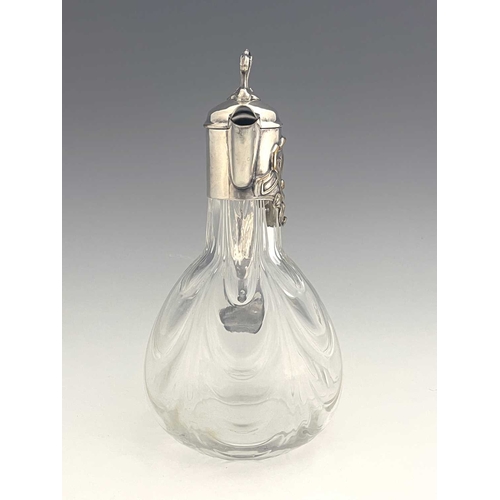 92 - A Jugendstil silver plate and glass claret jug, circa 1900, the optic swag moulded body of bulbous f... 