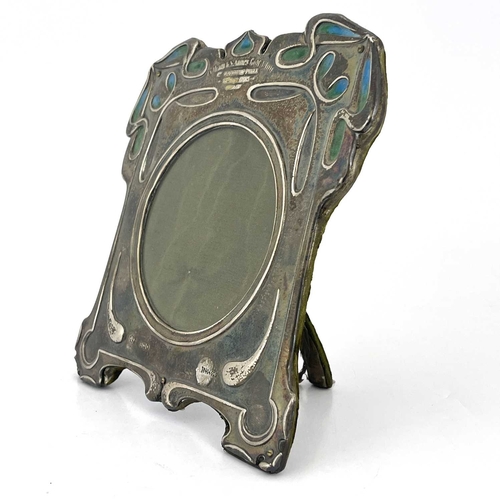 99 - Kate Harris for William Hutton, an Arts and Crafts silver photo frame, London 1902, square bracket f... 