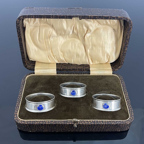 104 - Charles Horner, three Arts and Crafts silver and enamelled napkin rings, Chester 1917 and 1923, circ... 