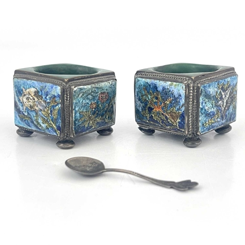 110 - A pair of Arts and Crafts enamelled and silver plated salt cellars, circa 1910, cuboid form each wit... 