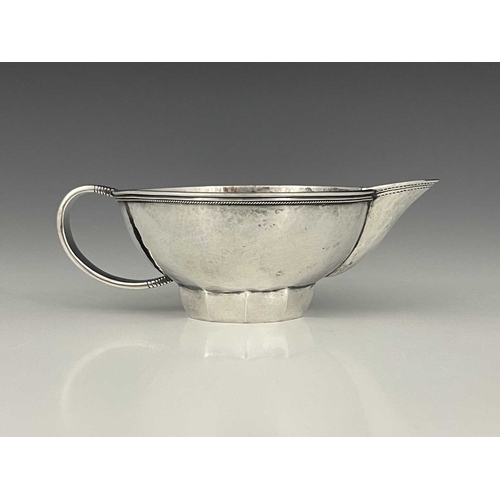 111 - Edward Spencer for Artificers Guild, an Arts and Crafts silver sauce boat, London 1932, planished ov... 