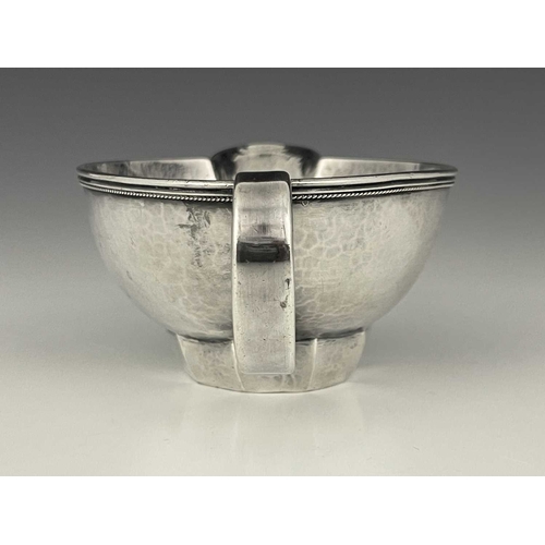 111 - Edward Spencer for Artificers Guild, an Arts and Crafts silver sauce boat, London 1932, planished ov... 