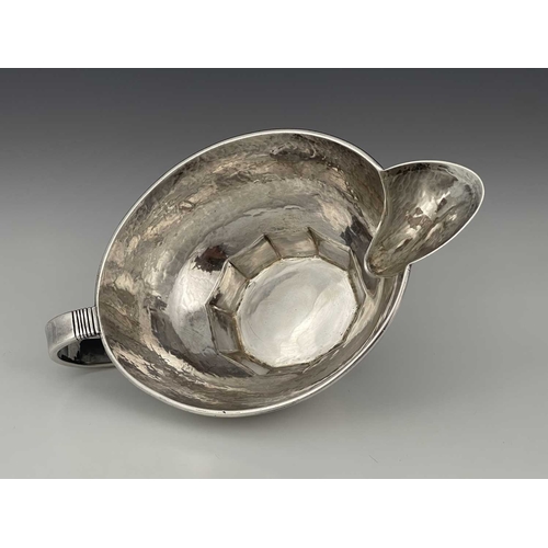 111 - Edward Spencer for Artificers Guild, an Arts and Crafts silver sauce boat, London 1932, planished ov... 